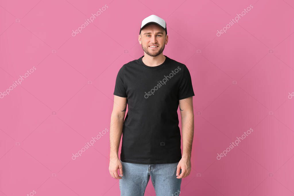 Handsome man in stylish cap on color background