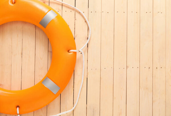 Lifebuoy ring on wooden background