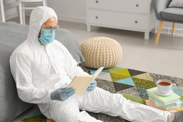 Man Biohazard Suit Reading Book Home — Stock Photo, Image