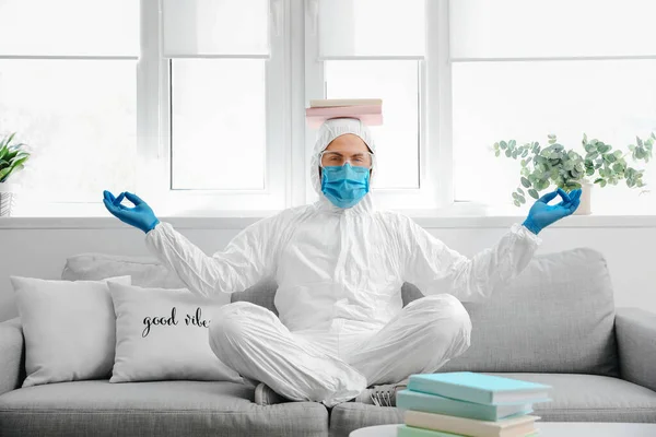 Man Biohazard Suit Books Meditating Home — Stock Photo, Image