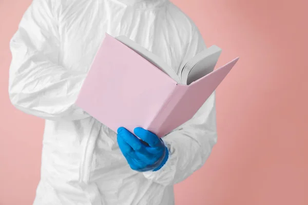 Man Biohazard Suit Reading Book Color Background Closeup — Stock Photo, Image