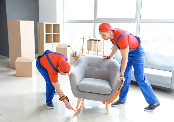 Loaders carrying furniture by using cargo belts