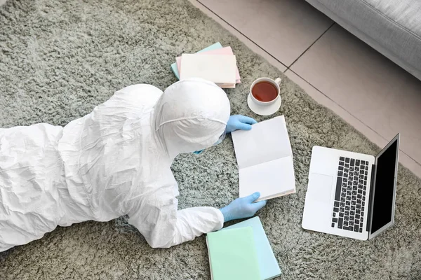 Man Biohazard Suit Reading Book Home — Stock Photo, Image