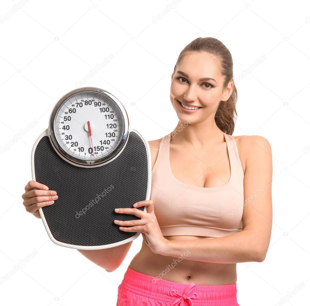 Young woman with weight scales on white background