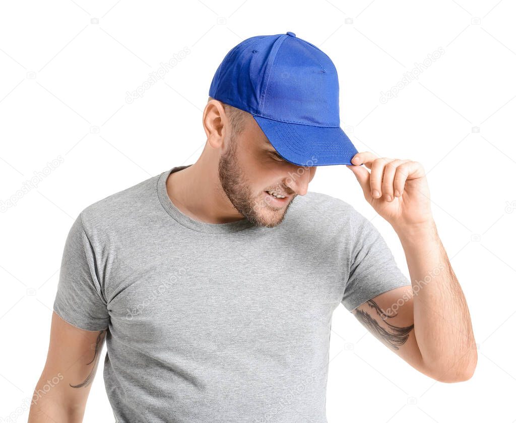Handsome man in stylish cap on white background