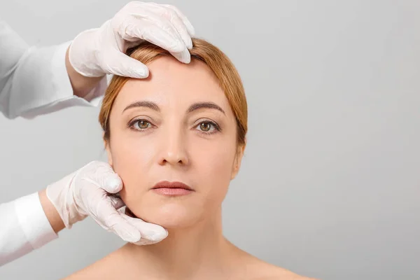 Plastic Surgeon Examining Woman Face Grey Background — Stock Photo, Image