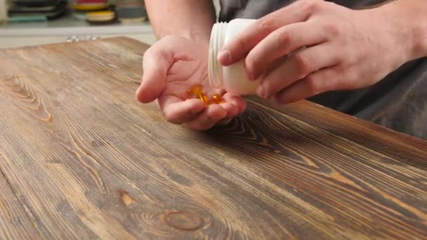 Man Fish Oil Capsules Wooden Table Closeup — Stock Video