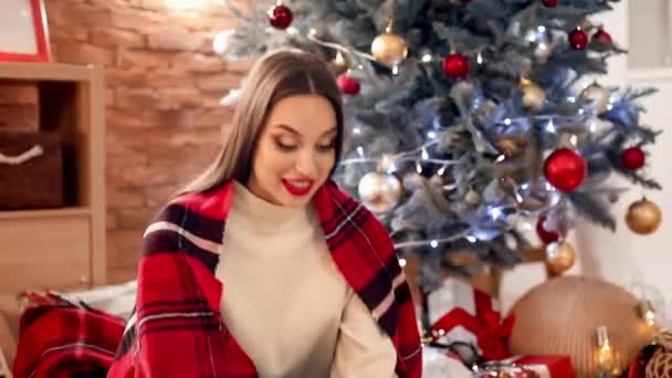 Beautiful Young Woman Opening Bad Christmas Gift Home — Stock Video