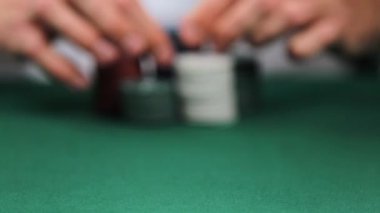 Man playing poker in casino, closeup