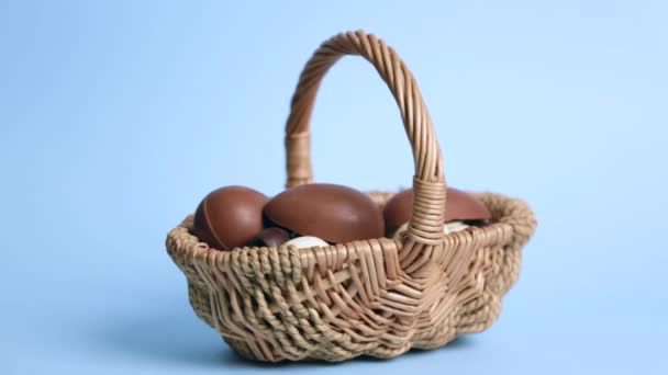 Woman Putting Chocolate Easter Egg Basket Color Background — Stock Video