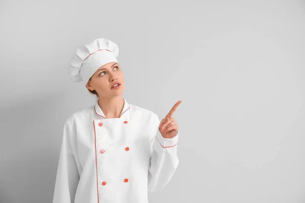 Beautiful Female Chef Pointing Something Light Background — Stock Photo, Image