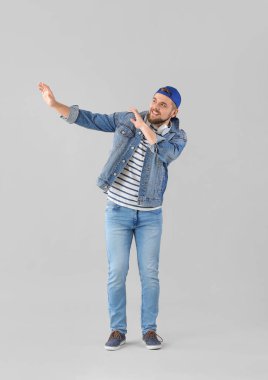 Yakışıklı genç adam arka planda dans ediyor.