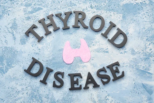 Text THYROID DISEASE on color background