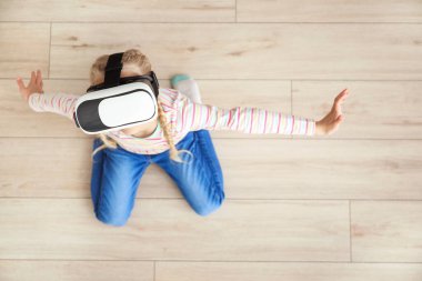 Evde VR gözlüklü şirin bir kız.