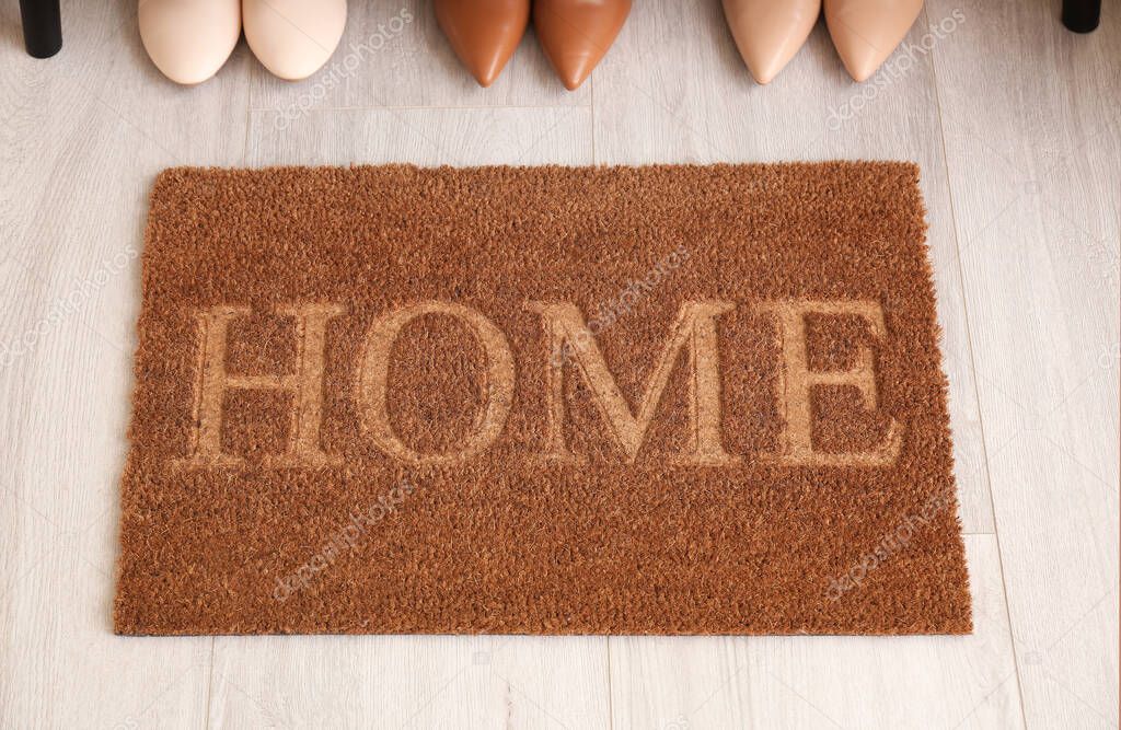 Door mat and shoes on floor