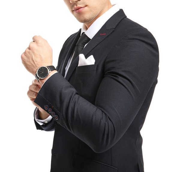 Handsome young man in elegant suit on white background