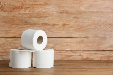 Ahşap arka planda tuvalet kağıdı ruloları
