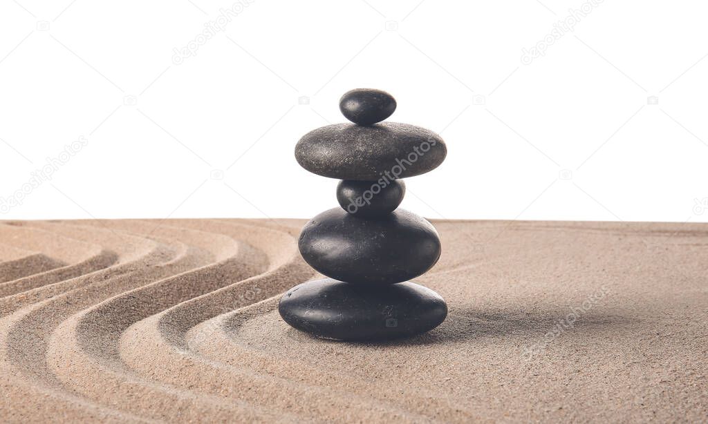 Stones on sand with lines against white background. Zen concept