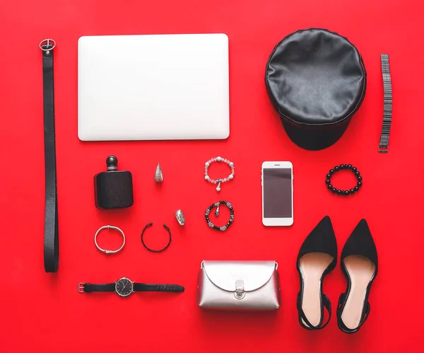 Female accessories with laptop and mobile phone on color background