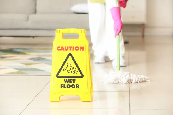 stock image Housewife cleaning floor in room