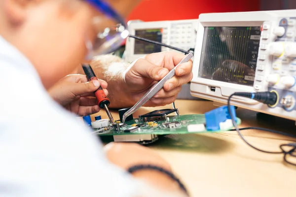 Young boy working on an electronics project — Stock Photo, Image