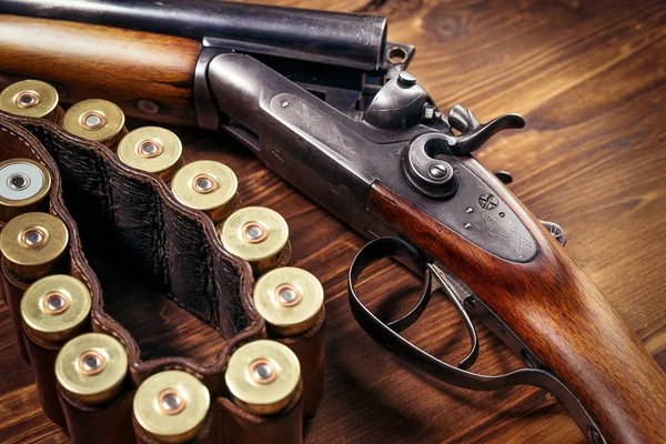 Κυνηγετικό όπλο με κοχύλια σε φόντο ξύλινη — Φωτογραφία Αρχείου