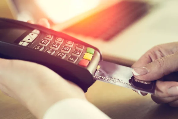 Female hand inserting credit card into a reader — Stock Photo, Image