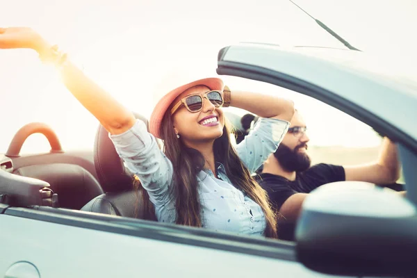 Freedom of the open road.Young Couple Driving Along Country Road In Open Top Car. — Stock Photo, Image