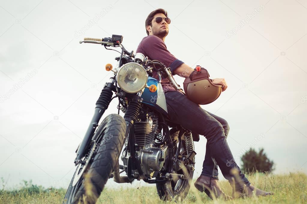Young biker with his motorcycle
