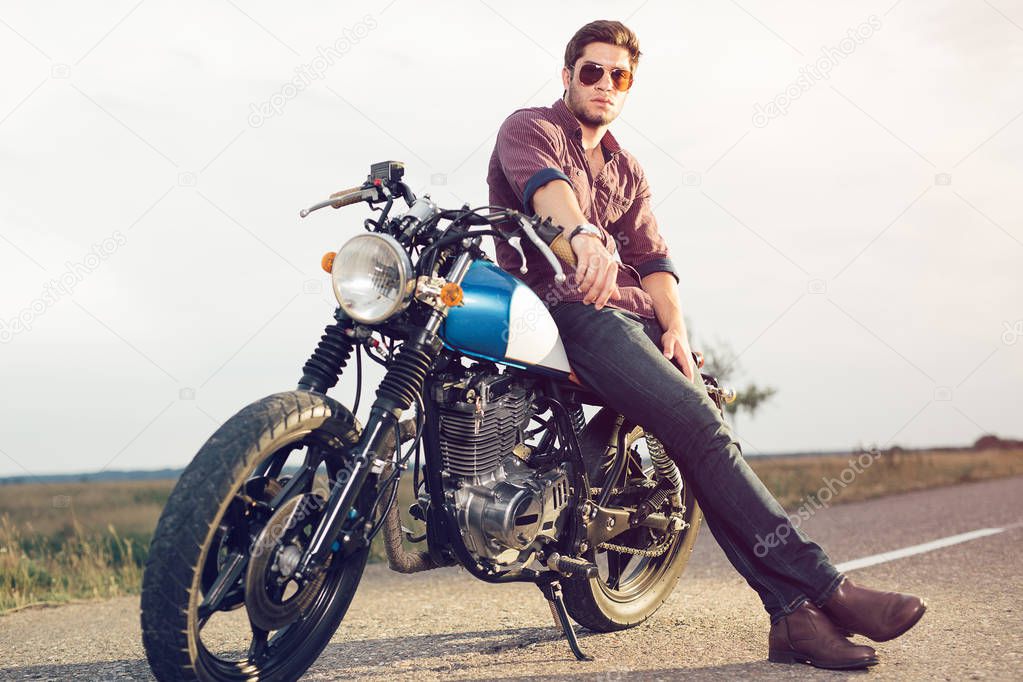 Young biker with his motorcycle