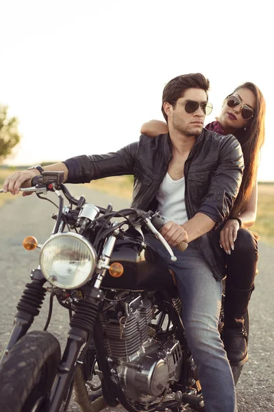 Sexy couple of bikers on the vintage custom motorcycle