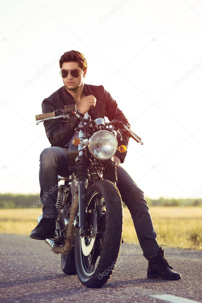 Biker man sits on a bike