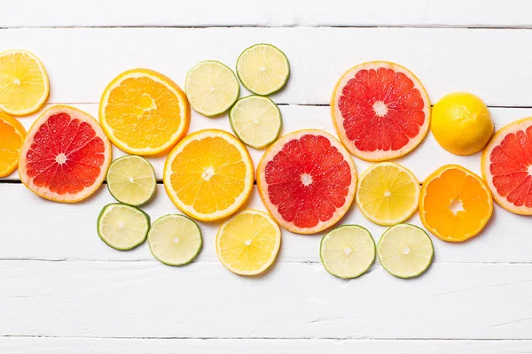 Frutas cítricas. Laranjas, limas e limões. Sobre o fundo da mesa de madeira com espaço de cópia — Fotografia de Stock