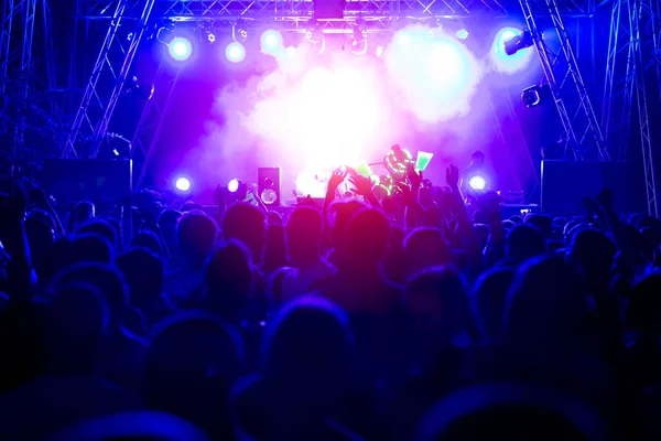 Crowd at concert and blurred stage lights