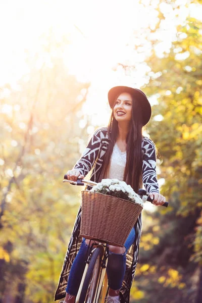 Happy active woman riding bike bicycle in fall autumn park — Stock Photo, Image