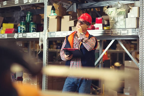 Happy businessman with clipboard at warehouse — Stock Photo, Image