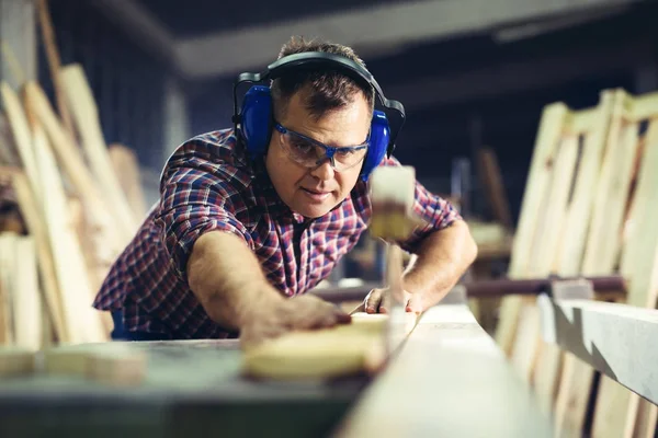 Carpinteiro fazendo seu trabalho na oficina de carpintaria — Fotografia de Stock