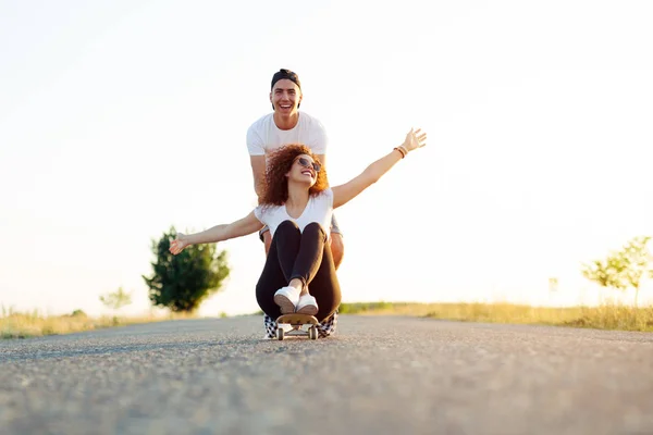 Happy Young Girl Sitting Longboard Being Pushed Her Friend — Stock Photo, Image