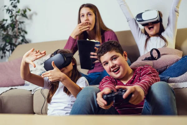 Teenagers playing video game at home.