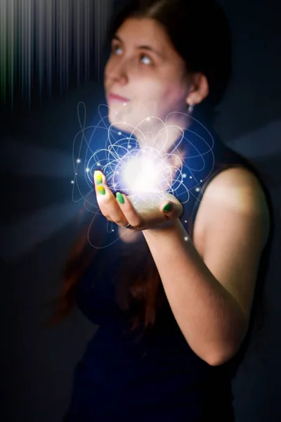 Energy ball in the hands of a young woman - new technology, energy. Glowing ball.