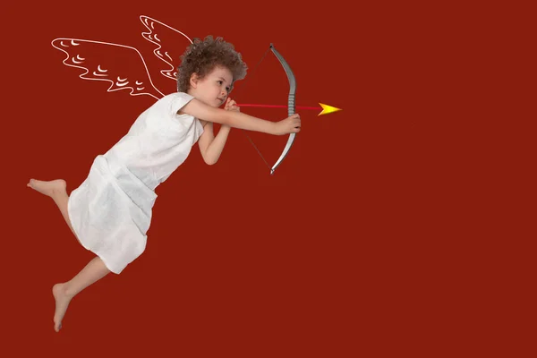 Cupid boy with wings and a shooting bow, at the end of the arrow a red heart. Valentines day, romance, love concept. — Stock Photo, Image