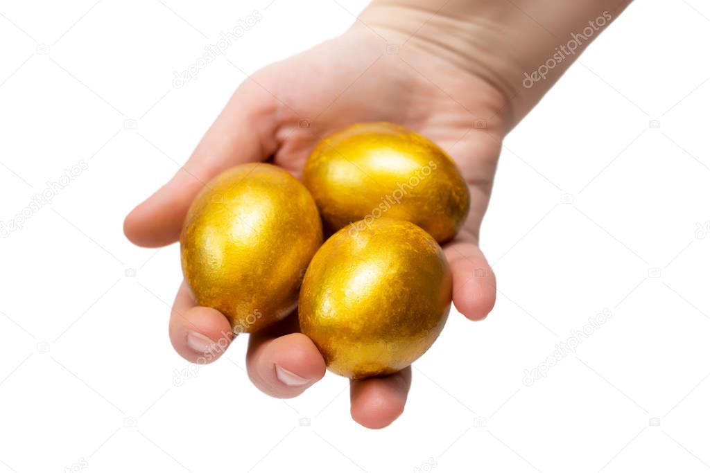 three golden egg un the hands. For easter theme design, wealth concept.