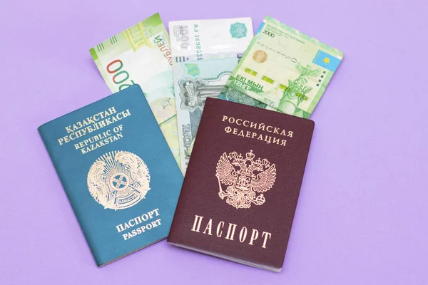 Passports of Russia and Kazakhstan with banknotes embedded in them. Documents of neighboring countries, the currency of Russia and Kazakhstan