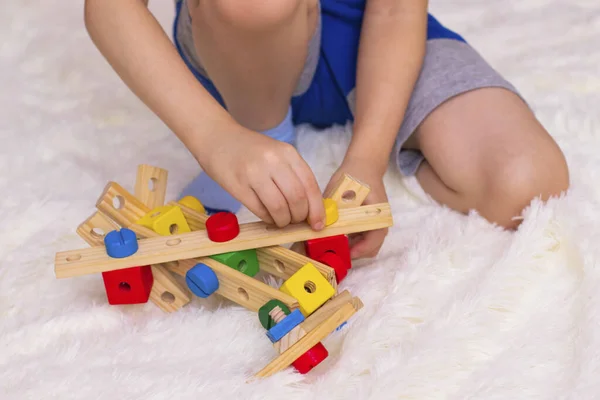 Little Boy Sits Floor Collects Plane Wooden Constructor Photo Stock Image