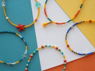 Bracelet and Necklace : Mixed beads with various materials  isolated on color paper