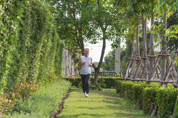 old man exercise by jogging at the park, health concept