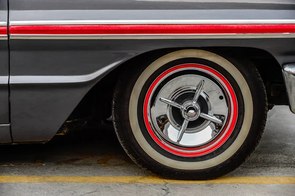 Close up of wheel disk and the side of a vintage automobile. antique classic car. Stock Picture