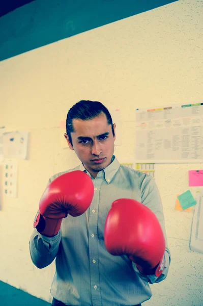 Geschäftsmann mit Boxhandschuhen schlägt im Büro vor die Kamera, Vintage-Stil, Business-Wettbewerbskonzept — Stockfoto