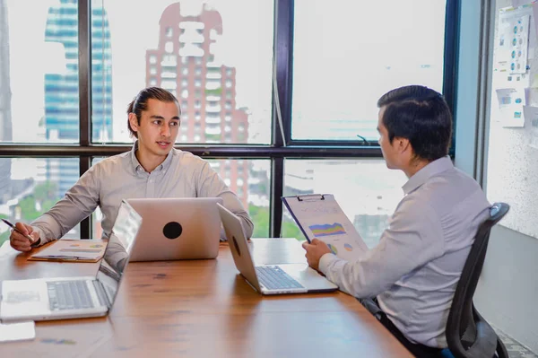 Dos hombres de negocios discutiendo el informe financiero y el informe anual en la oficina — Foto de Stock