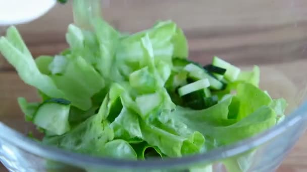 Closeup of falling cucumbers on glass bowl — Stock Video